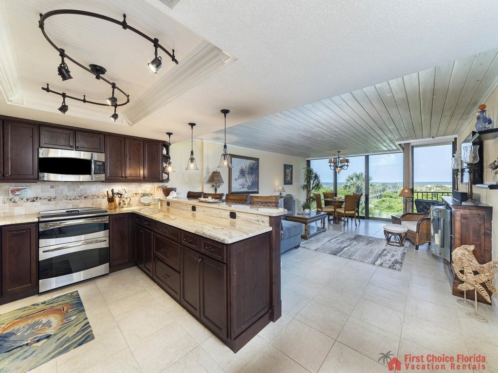 1 Dondanville Road, Unit 109B St. Augustine, FL 32080 - Photo 7 of 27 a large kitchen with a stove a sink and a microwave