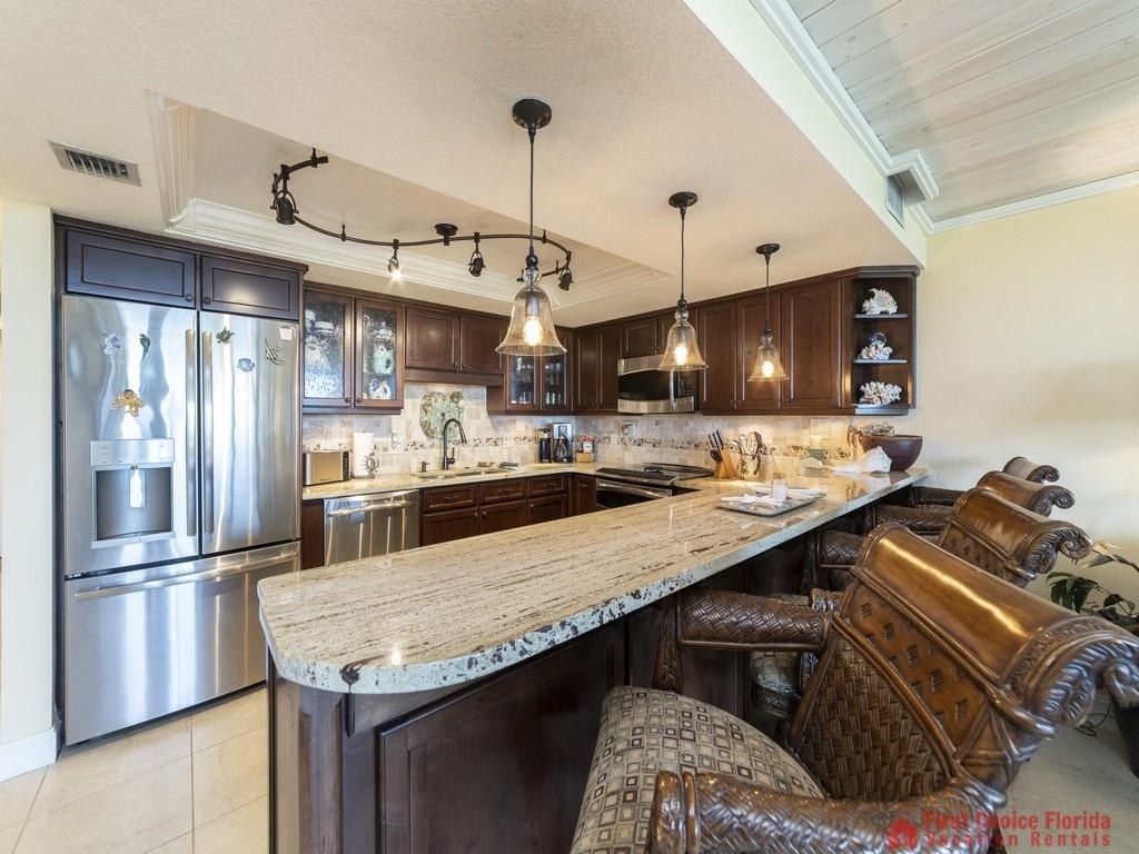 1 Dondanville Road, Unit 109B St. Augustine, FL 32080 - Photo 9 of 27 a kitchen with stainless steel appliances granite countertop a sink a stove and a refrigerator