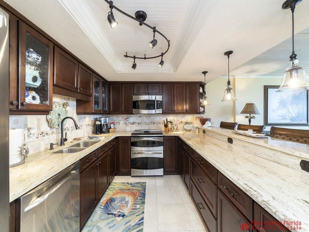 1 Dondanville Road, Unit 109B St. Augustine, FL 32080 - Photo 10 of 27 a large kitchen with stainless steel appliances granite countertop a sink and cabinets