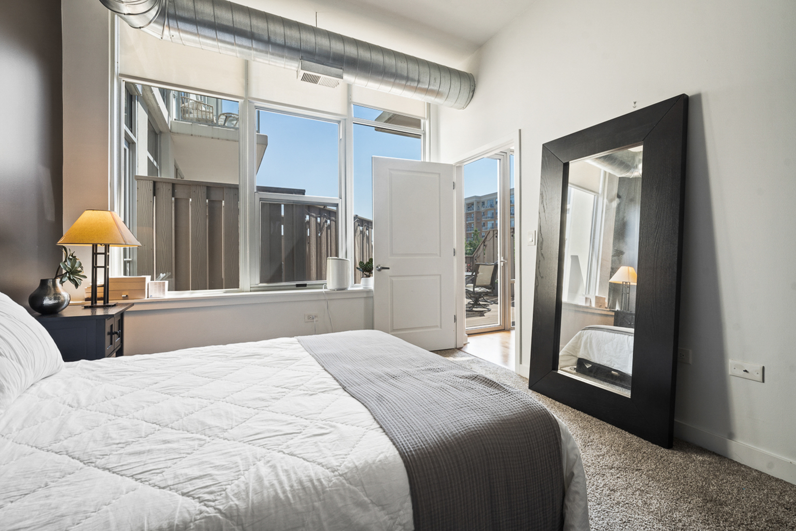 901 West Madison Street, Unit 401 Chicago, IL 60607 - Photo 11 of 19 a bedroom with a bed and a window