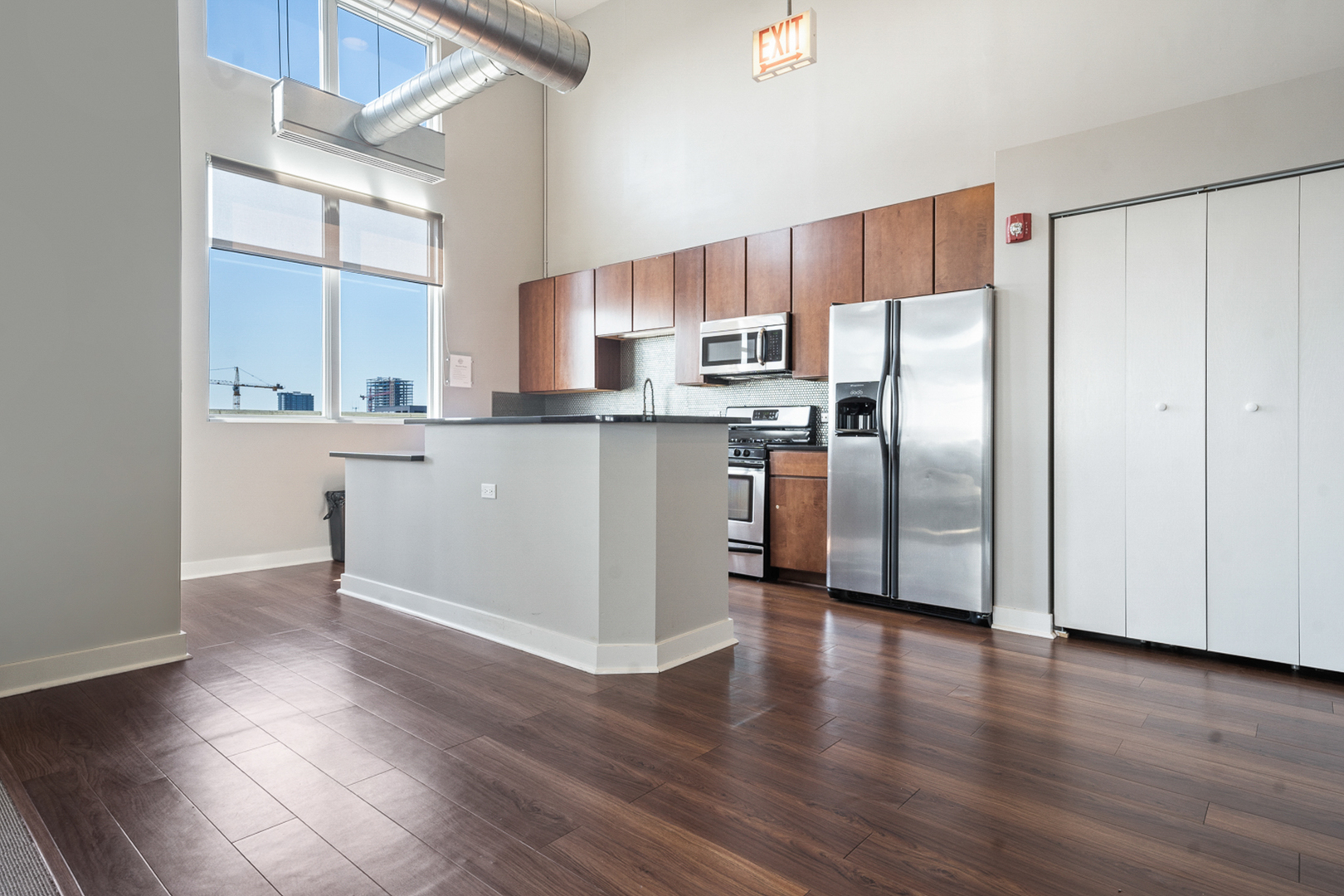 901 West Madison Street, Unit 401 Chicago, IL 60607 - Photo 15 of 19 a kitchen with stainless steel appliances wooden floor and a window