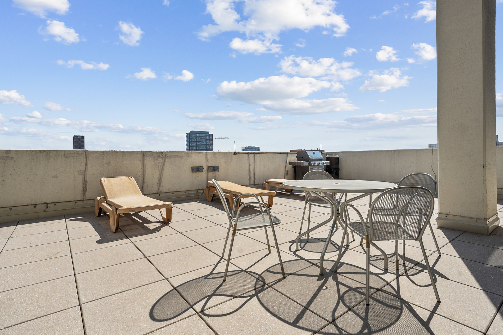 901 West Madison Street, Unit 401 Chicago, IL 60607 - Photo 17 of 19 a roof deck with table and chairs