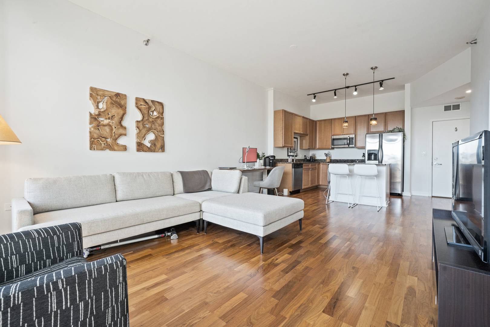 901 West Madison Street, Unit 401 Chicago, IL 60607 - Photo 3 of 19 a living room with furniture and kitchen view