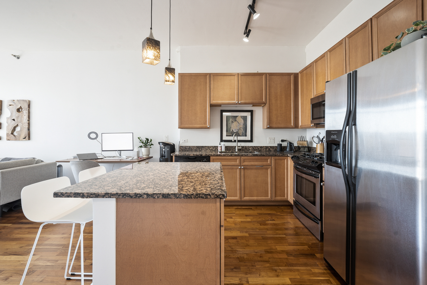 901 West Madison Street, Unit 401 Chicago, IL 60607 - Photo 8 of 19 a kitchen with stainless steel appliances granite countertop a sink refrigerator and microwave