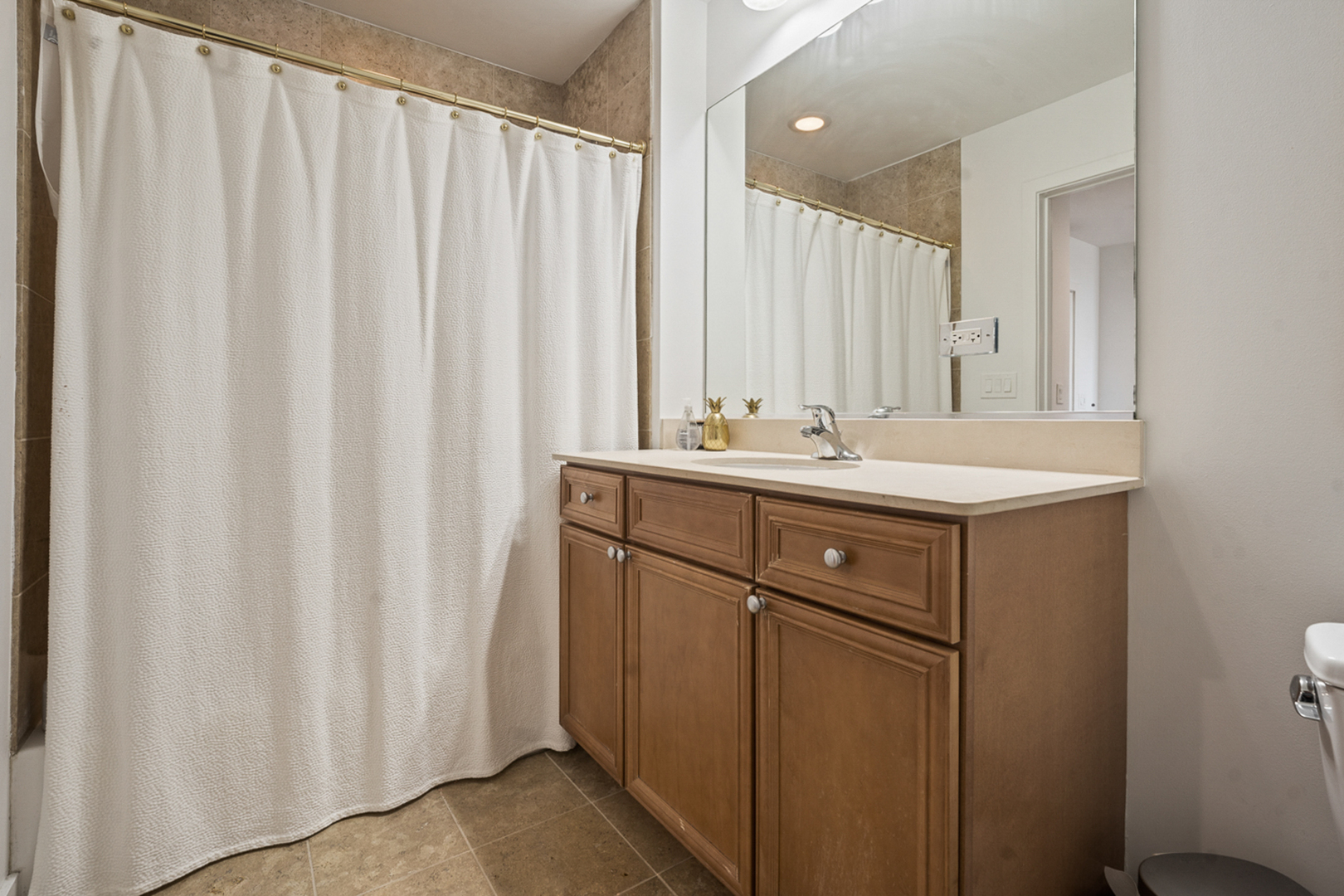 901 West Madison Street, Unit 401 Chicago, IL 60607 - Photo 9 of 19 a bathroom with a sink a mirror and a shower curtain