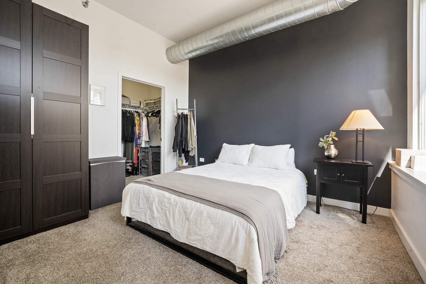 901 West Madison Street, Unit 401 Chicago, IL 60607 - Photo 10 of 19 a bedroom with a bed and a lamp