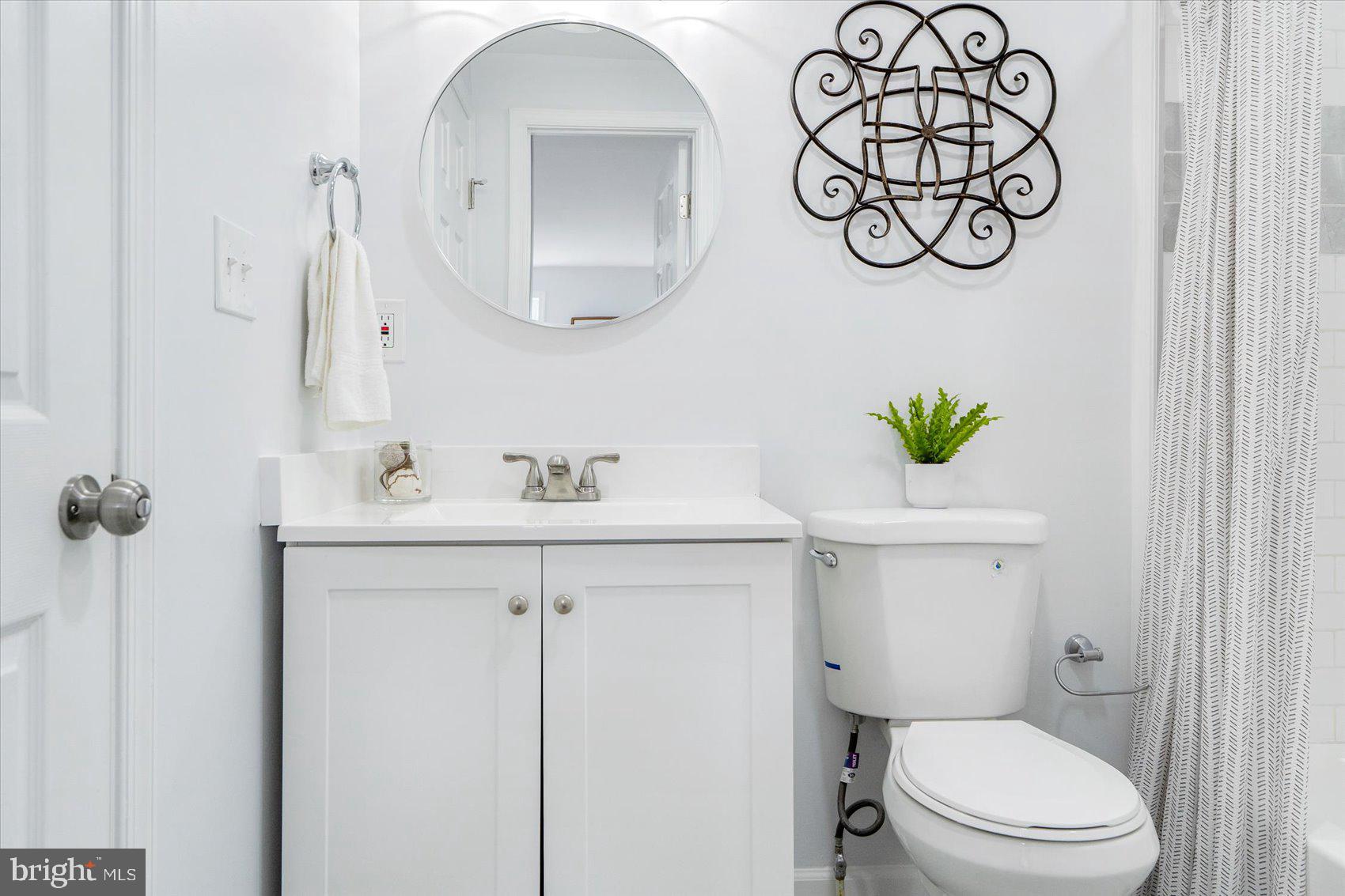 1432 Carroll Street Baltimore, MD 21230 - Photo 18 of 29 a bathroom with a toilet sink and mirror
