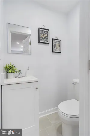 a bathroom with a sink mirror and toilet
