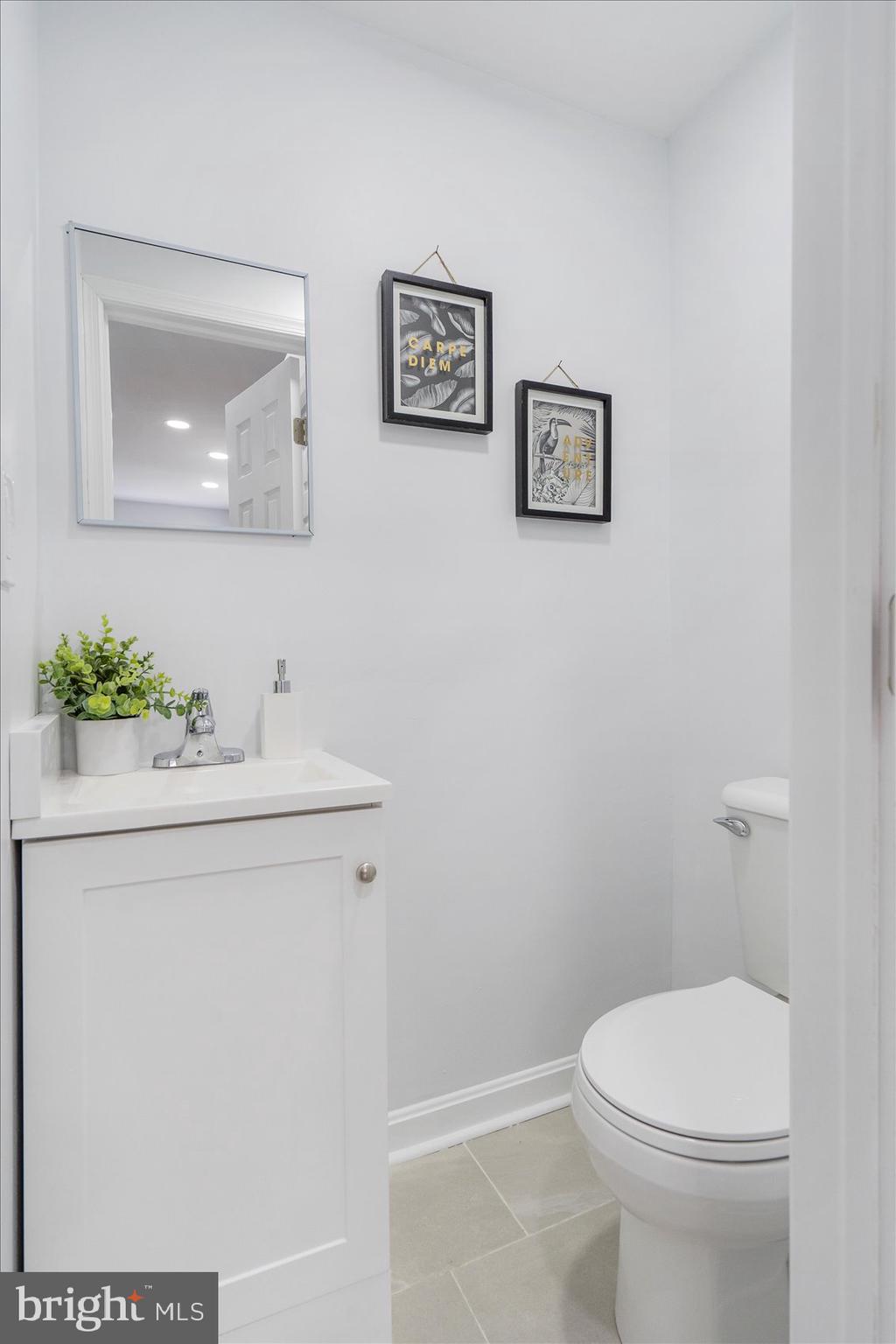 1432 Carroll Street Baltimore, MD 21230 - Photo 23 of 29 a bathroom with a sink mirror and toilet