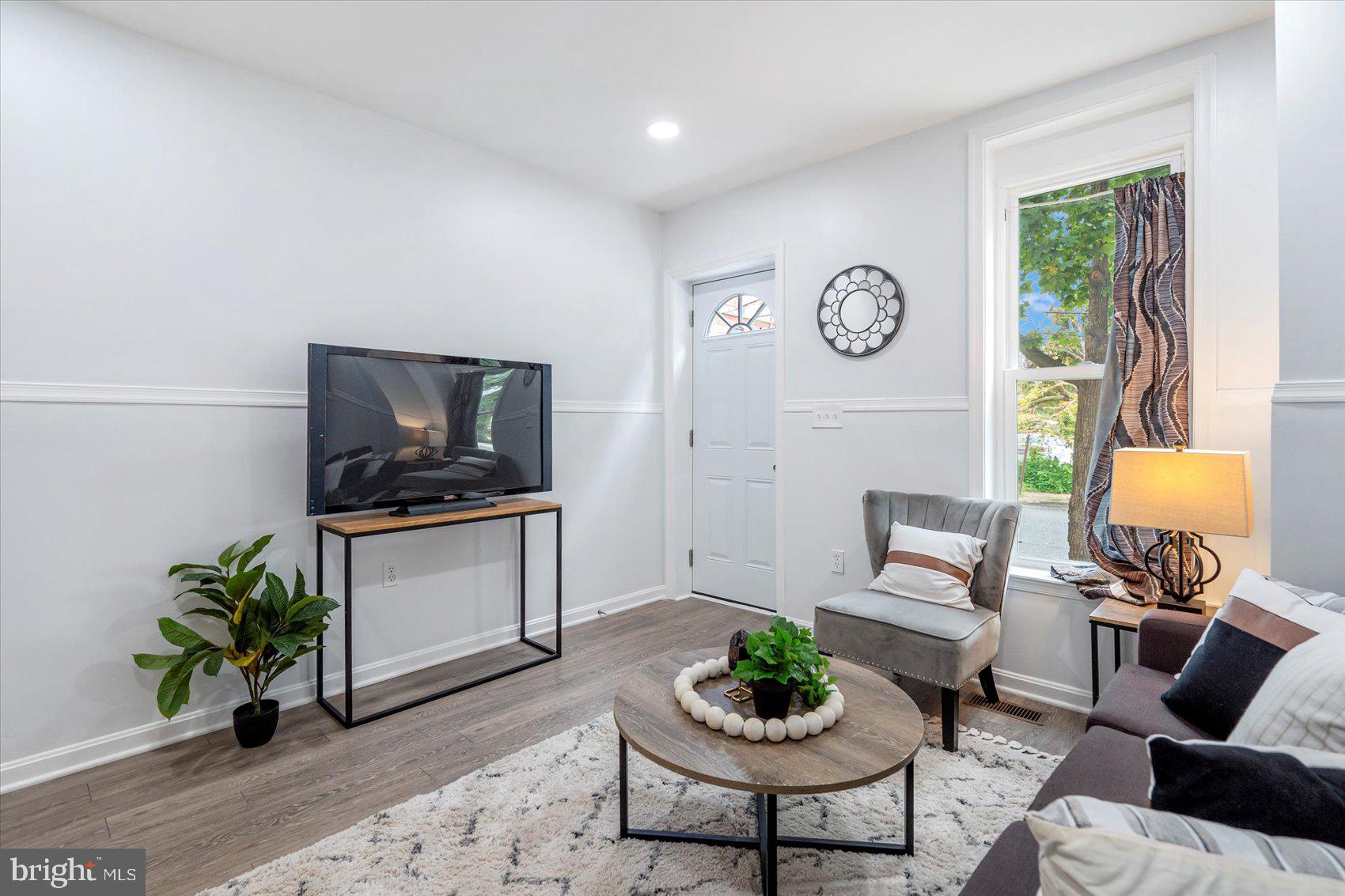 1432 Carroll Street Baltimore, MD 21230 - Photo 7 of 29 a living room with furniture a window and a potted plant