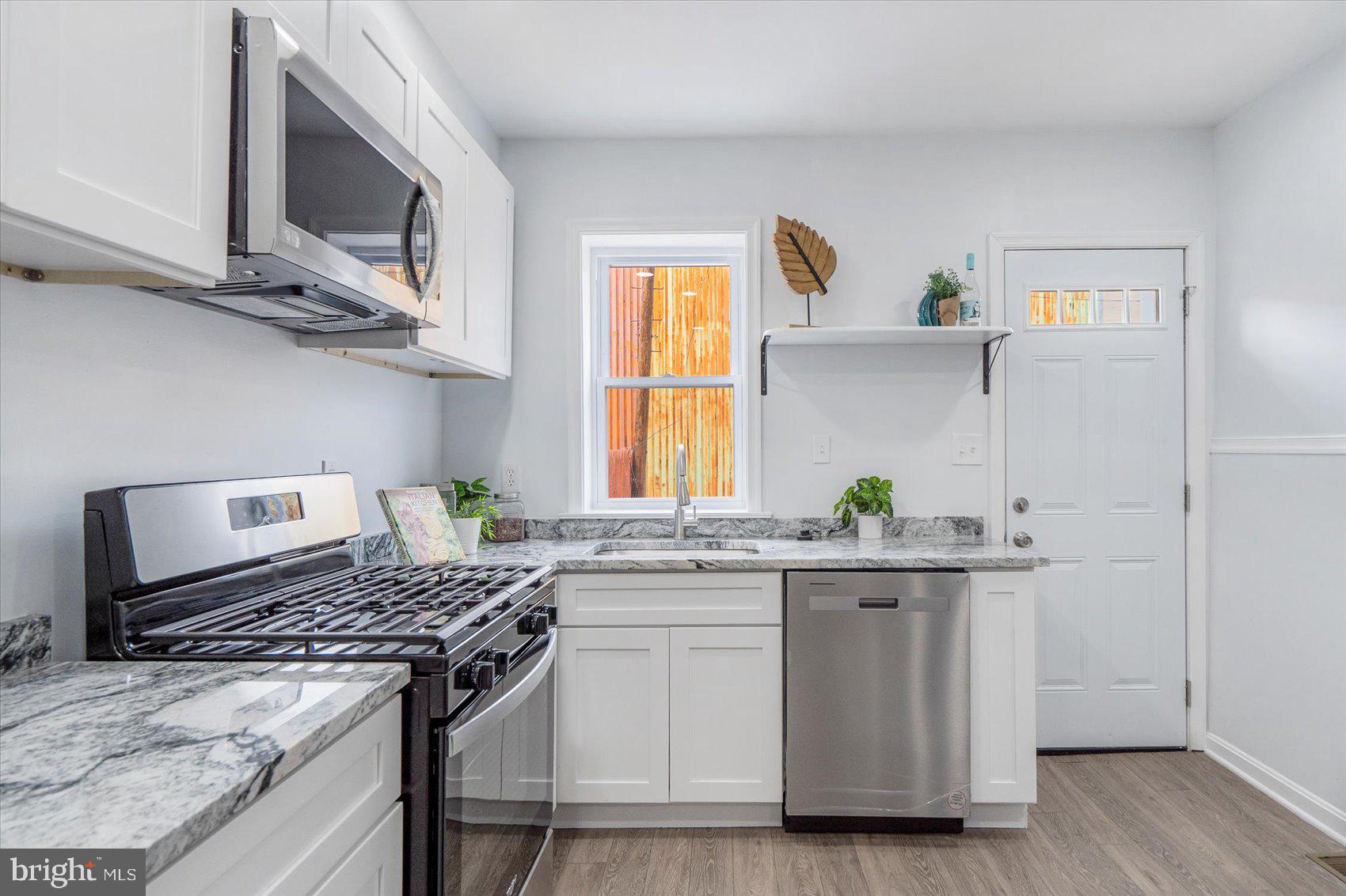 1432 Carroll Street Baltimore, MD 21230 - Photo 9 of 29 a kitchen with stainless steel appliances granite countertop a stove and a sink