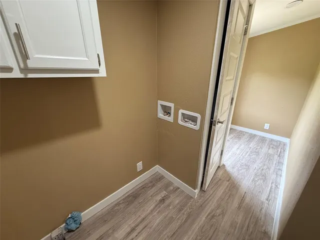 a view of a small space with wooden floor and a window