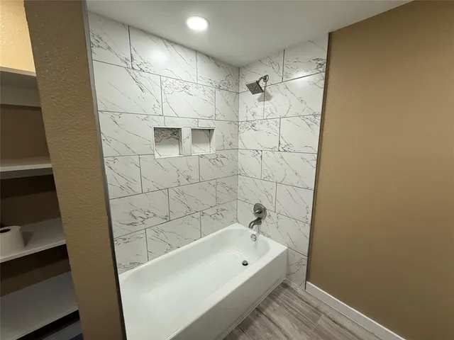 a bathroom with a bathtub and a shower