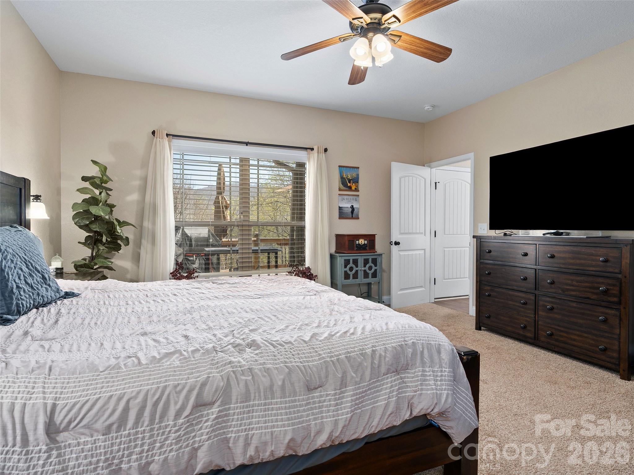 4823 Max Patch Road Clyde, NC 28721 - Photo 17 of 32 a bedroom with a bed and a flat screen television