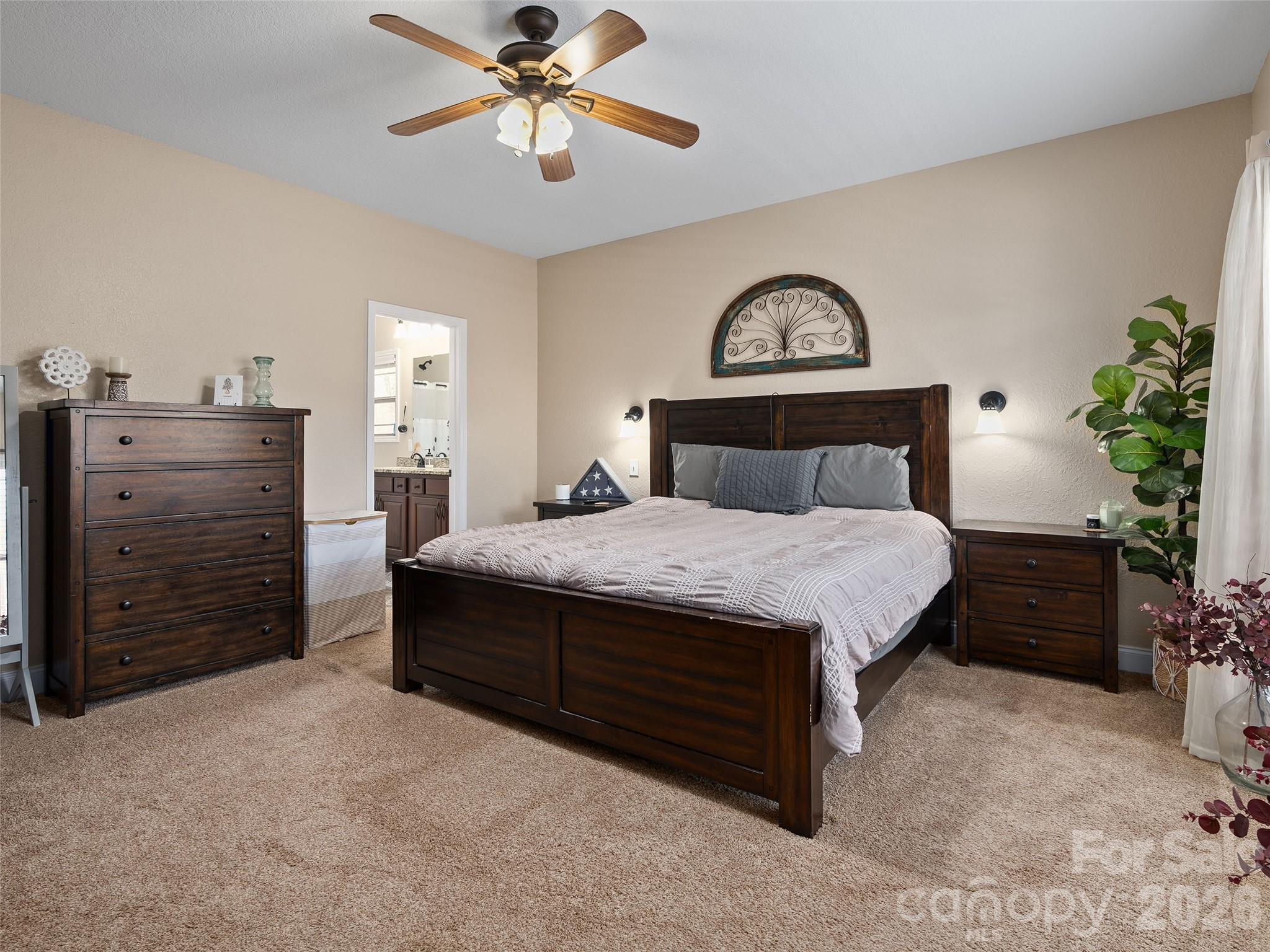 4823 Max Patch Road Clyde, NC 28721 - Photo 18 of 32 a bedroom with a bed and a chandelier