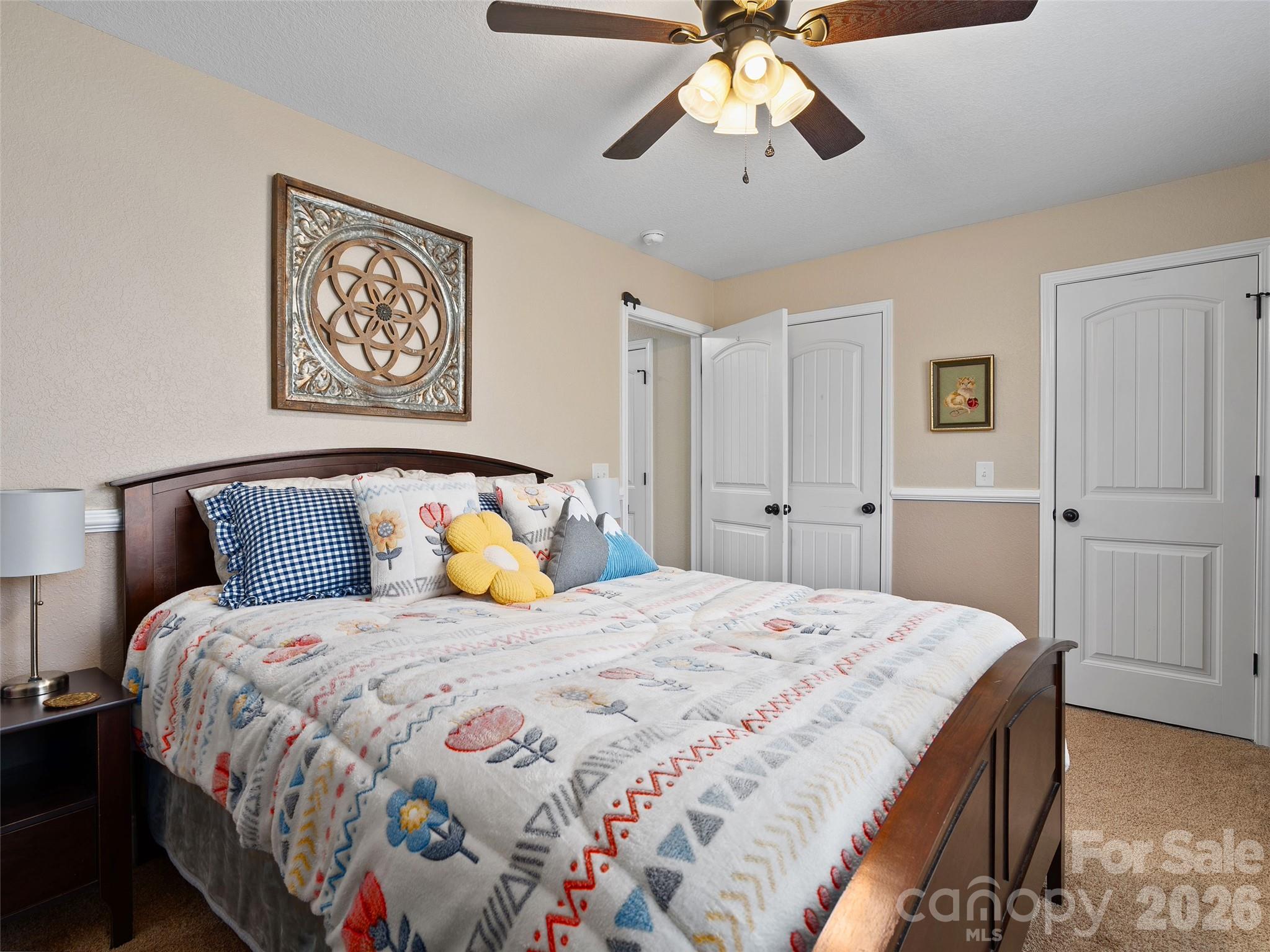 4823 Max Patch Road Clyde, NC 28721 - Photo 25 of 32 a bedroom with a bed and a chandelier