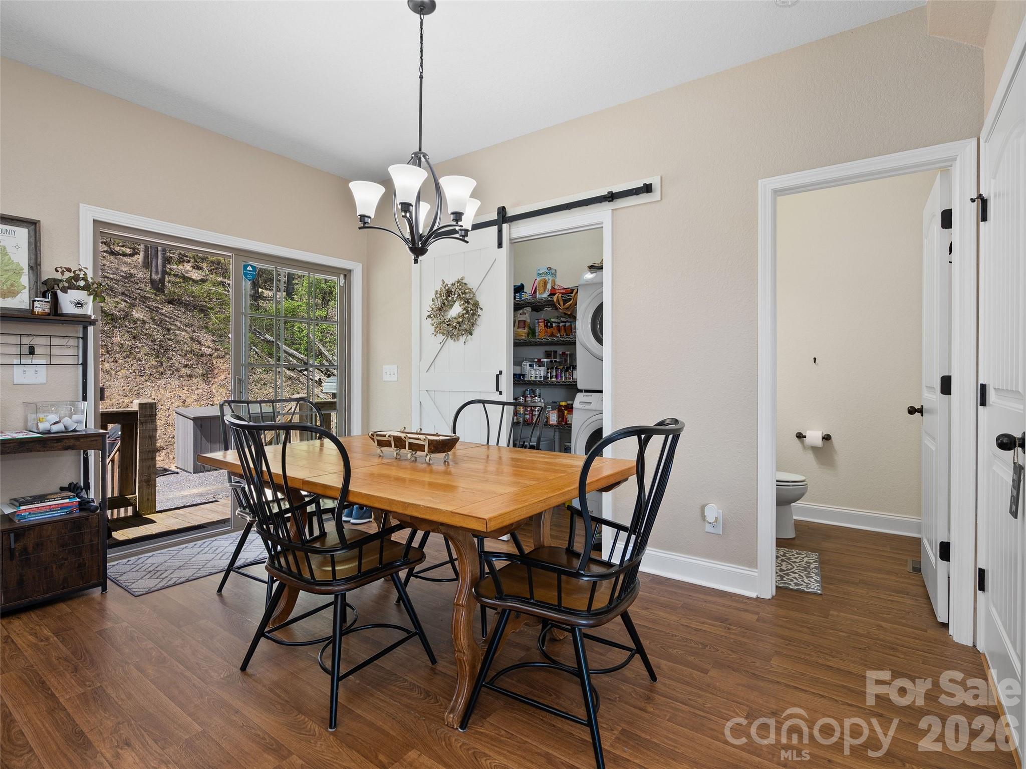 4823 Max Patch Road Clyde, NC 28721 - Photo 4 of 32 a view of a dining room with furniture window and wooden floor