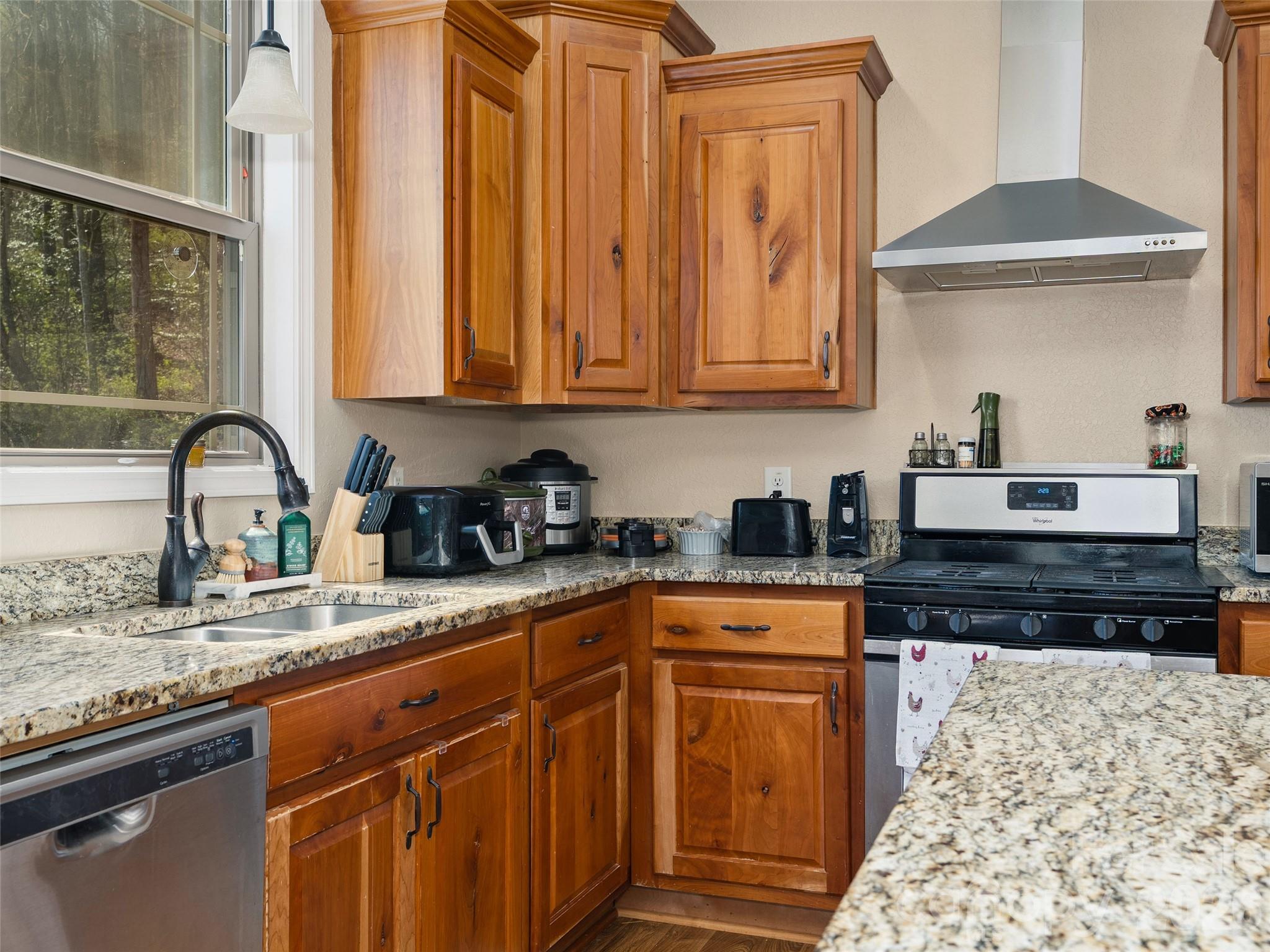 4823 Max Patch Road Clyde, NC 28721 - Photo 7 of 32 a kitchen with granite countertop stainless steel appliances a stove a sink and a microwave