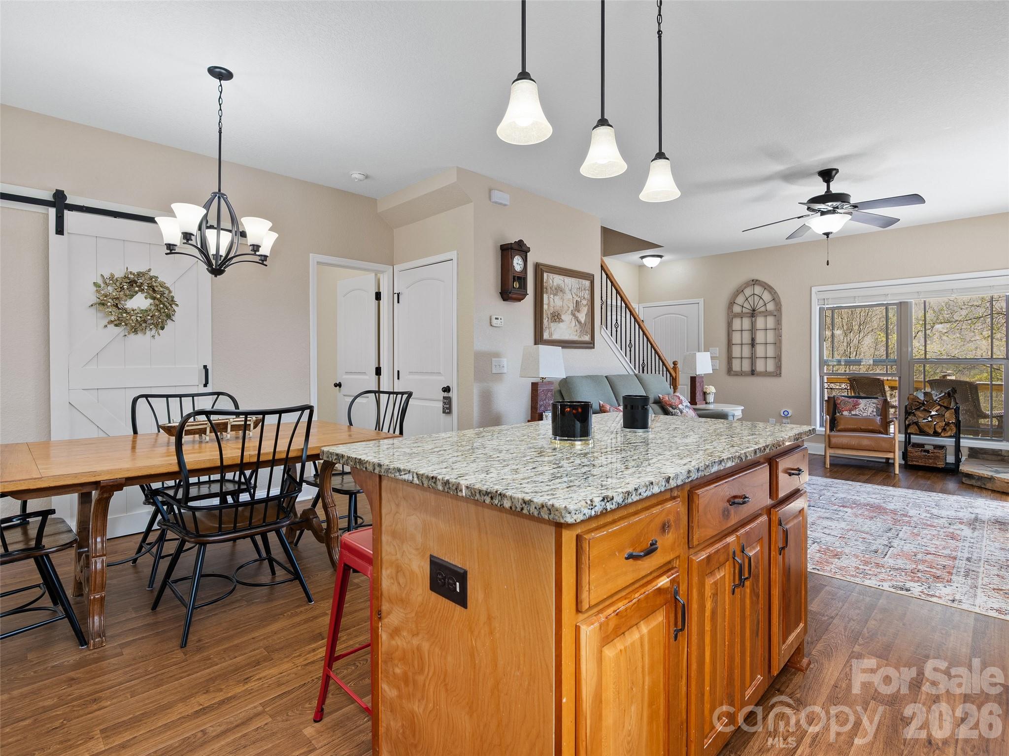 4823 Max Patch Road Clyde, NC 28721 - Photo 8 of 32 a kitchen with stainless steel appliances granite countertop a kitchen island a stove and a wooden floors