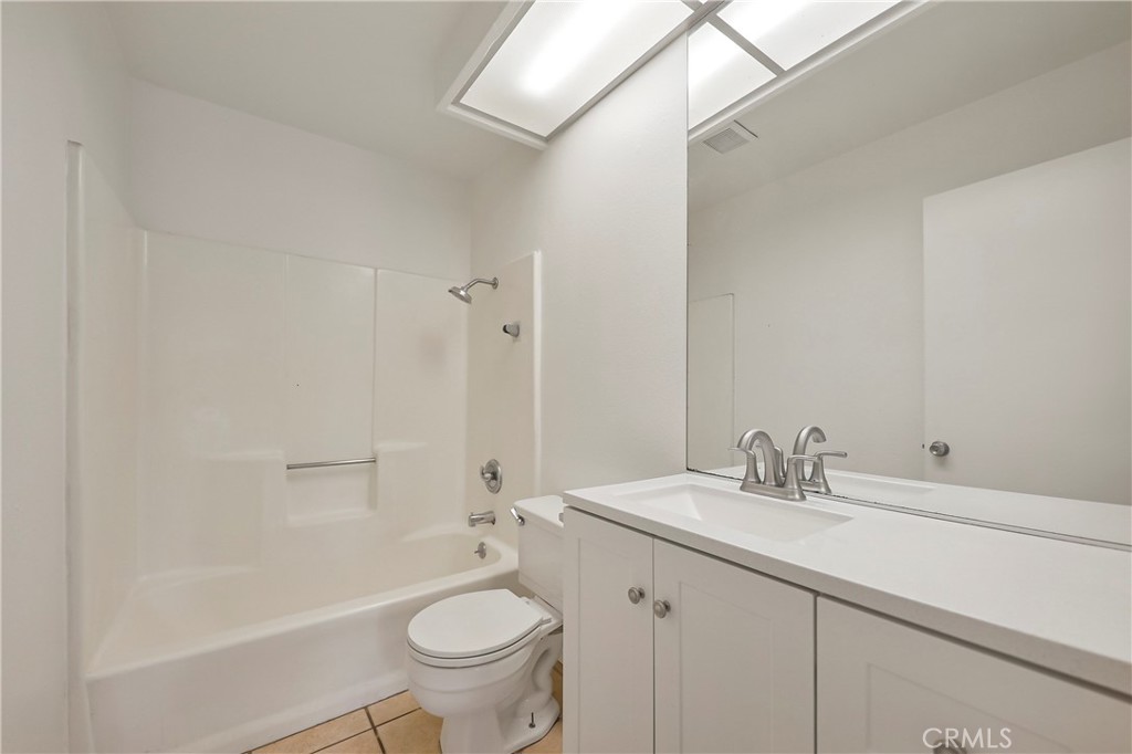 45546 Aladdin Street, Unit B101 Indio, CA 92201 - Photo 13 of 18 a bathroom with a sink a toilet and shower