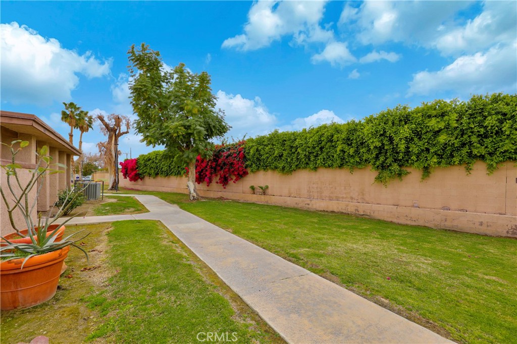 45546 Aladdin Street, Unit B101 Indio, CA 92201 - Photo 14 of 18 a view of yard with swimming pool and seating area