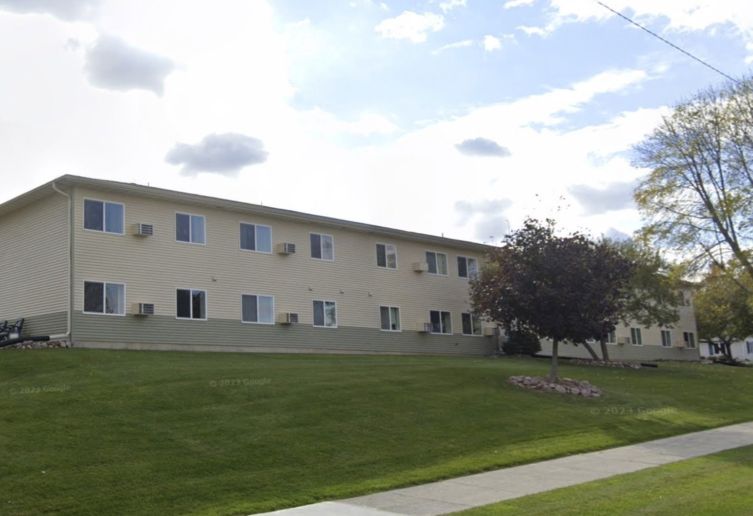 1485 North 7th Street Manitowoc, WI 54220 - Photo 2 of 11 a large building with trees in front of it
