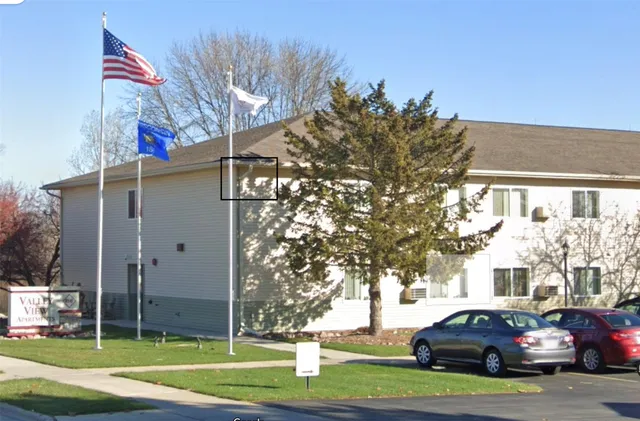 a view of a parked cars in front of a building