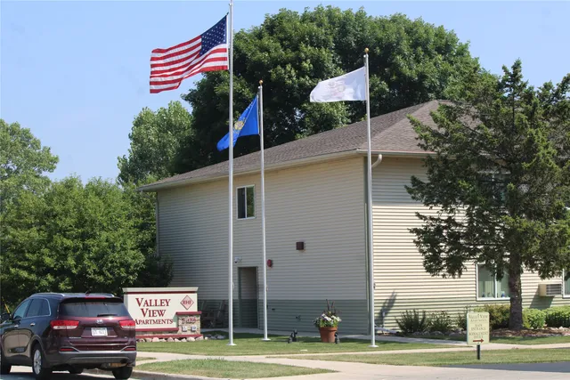 a front view of a building with trees