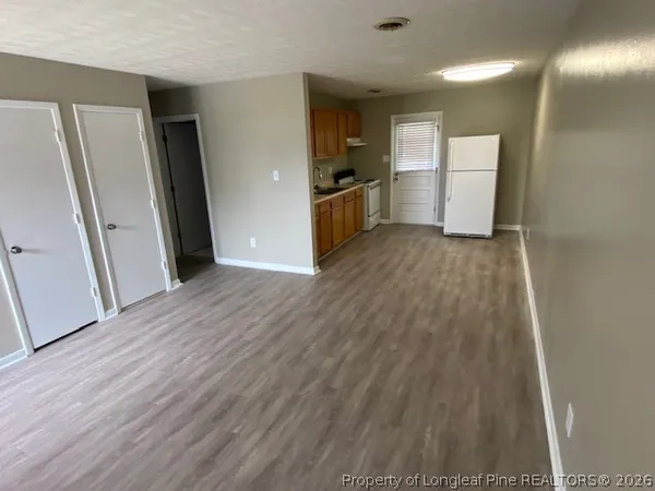 a view of a refrigerator in kitchen and a sink