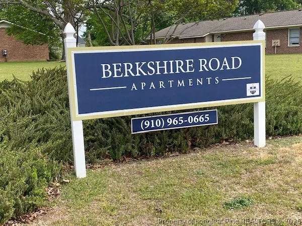a sign broad in front of red brick house