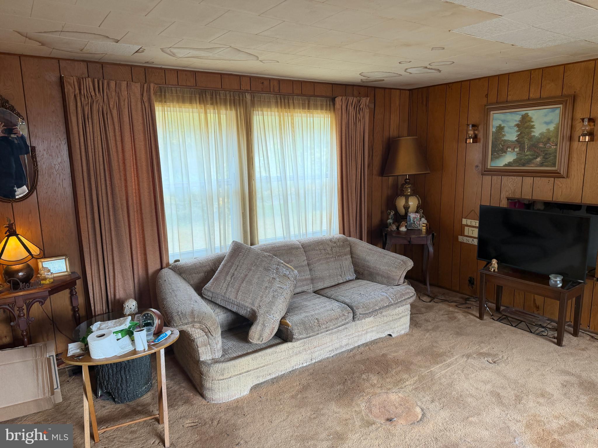 537 Dandelion Road Millville, NJ 08332 - Photo 27 of 33 a living room with furniture a flat screen tv and a window