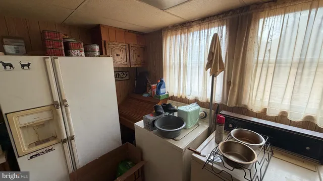 a kitchen with a refrigerator and a stove