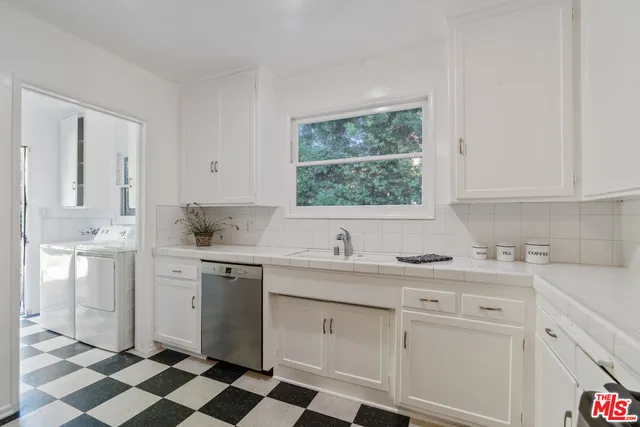 a kitchen with a sink stove and cabinets