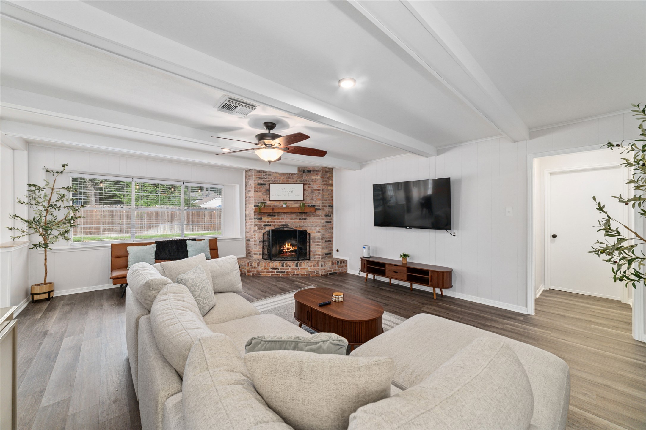 563 Landfall Lane Conroe, TX 77302 - Photo 11 of 25 a living room with furniture a fireplace and a flat screen tv