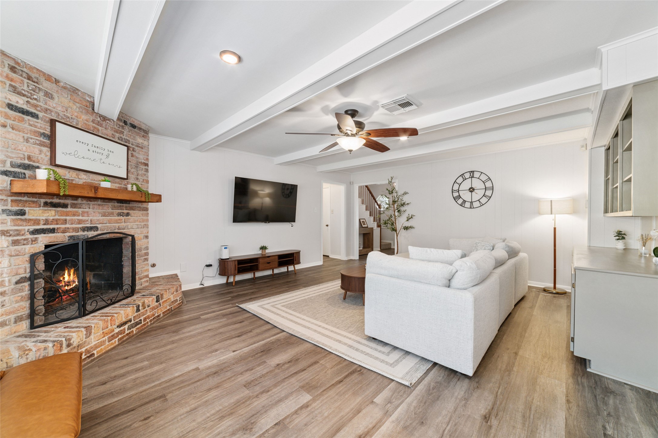 563 Landfall Lane Conroe, TX 77302 - Photo 12 of 25 a living room with furniture a fireplace and a flat screen tv