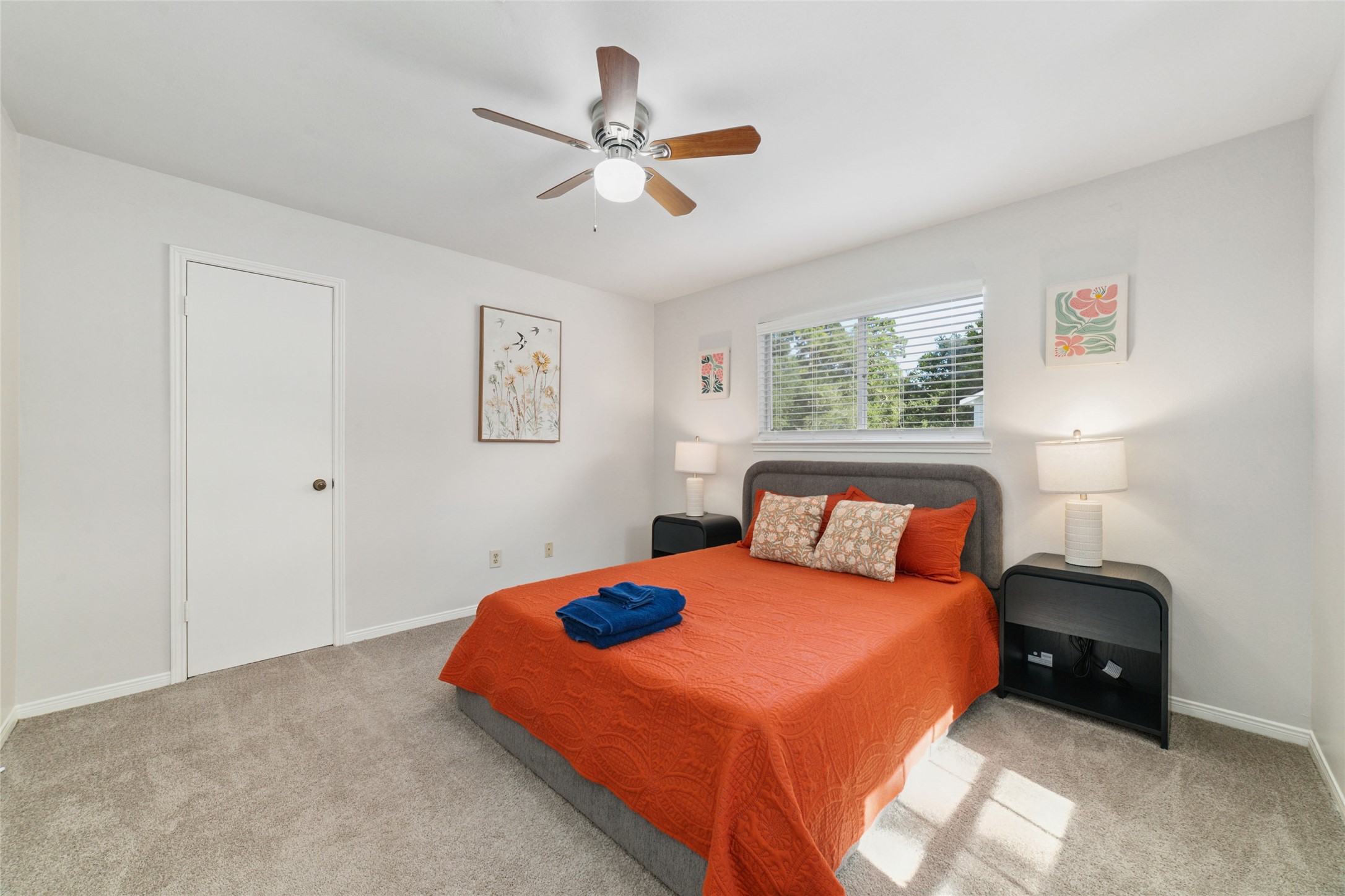 563 Landfall Lane Conroe, TX 77302 - Photo 17 of 25 a bedroom with a bed and a chandelier