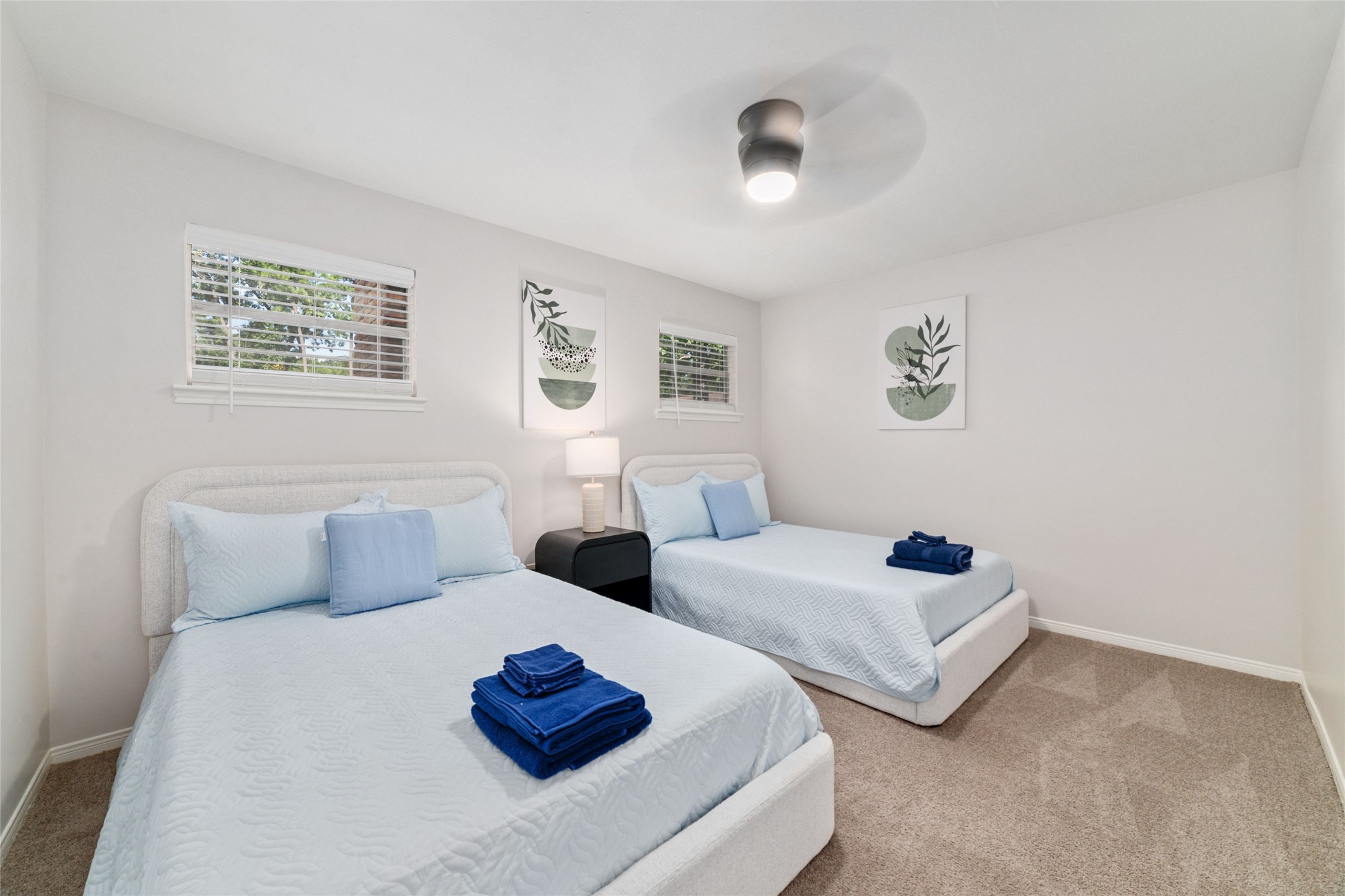 563 Landfall Lane Conroe, TX 77302 - Photo 18 of 25 a bedroom with two beds and painting on the wall