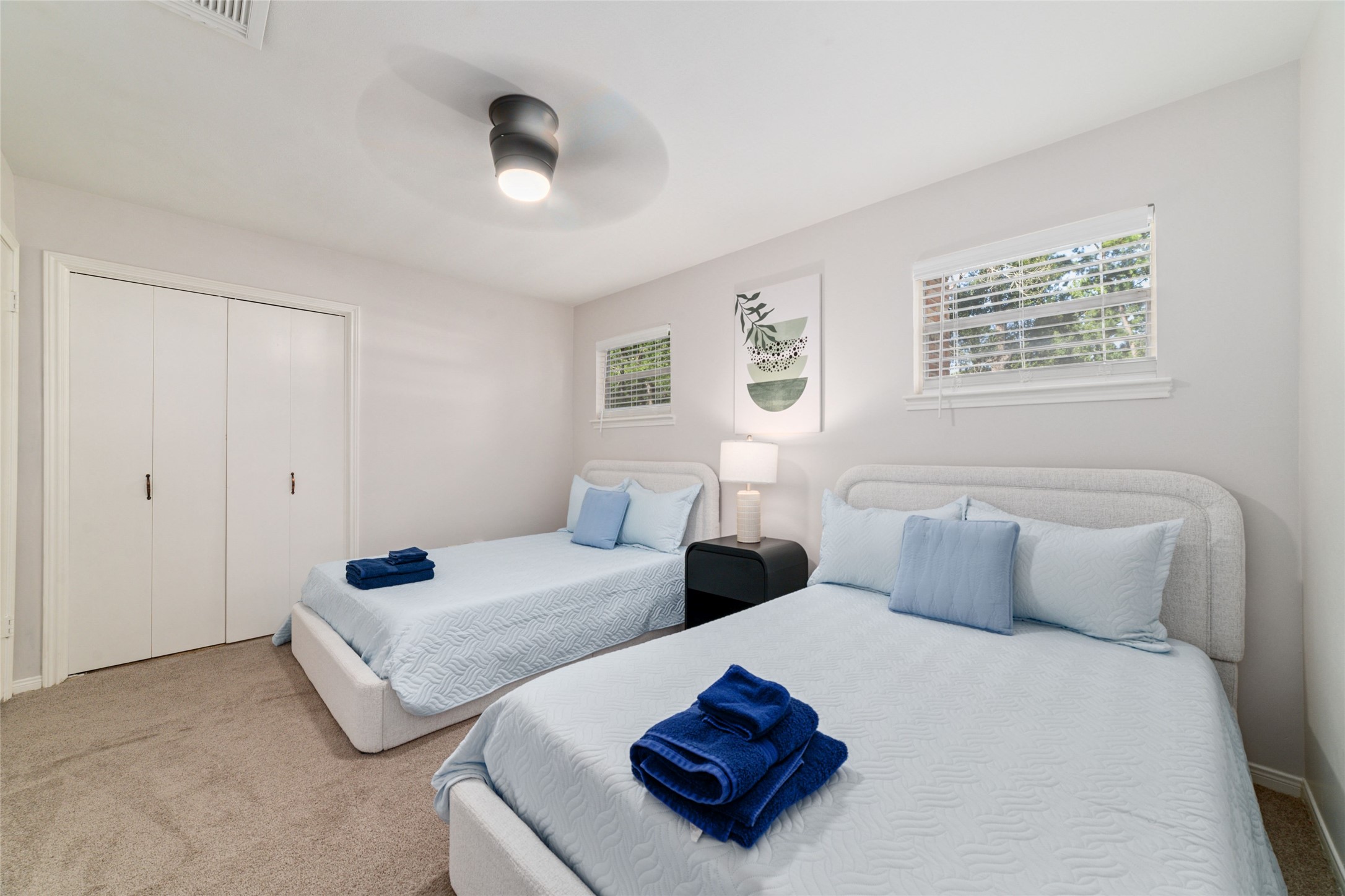 563 Landfall Lane Conroe, TX 77302 - Photo 19 of 25 a bedroom with two beds and painting on the wall