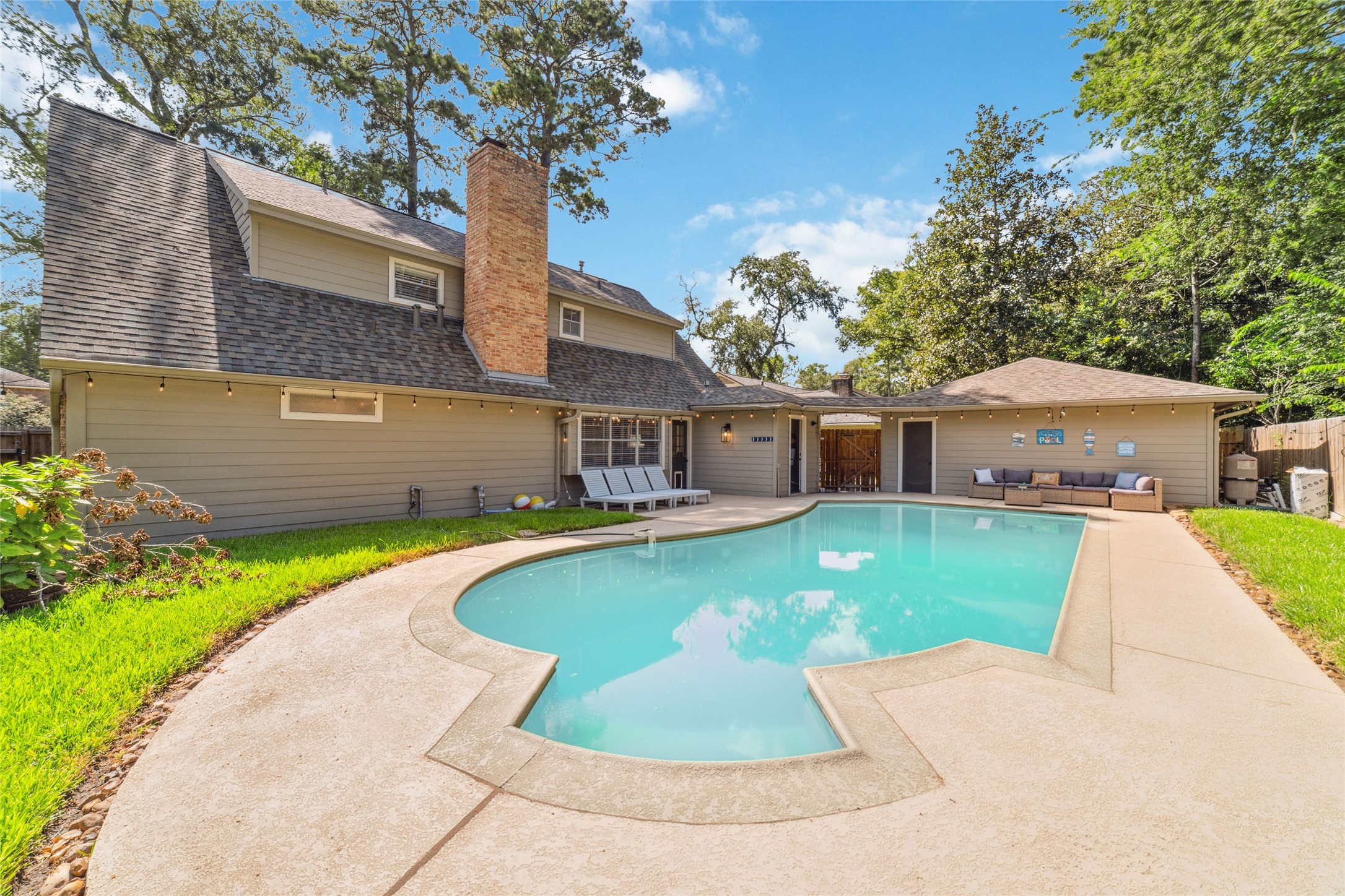 563 Landfall Lane Conroe, TX 77302 - Photo 3 of 25 a front view of a house with a garden and lake view
