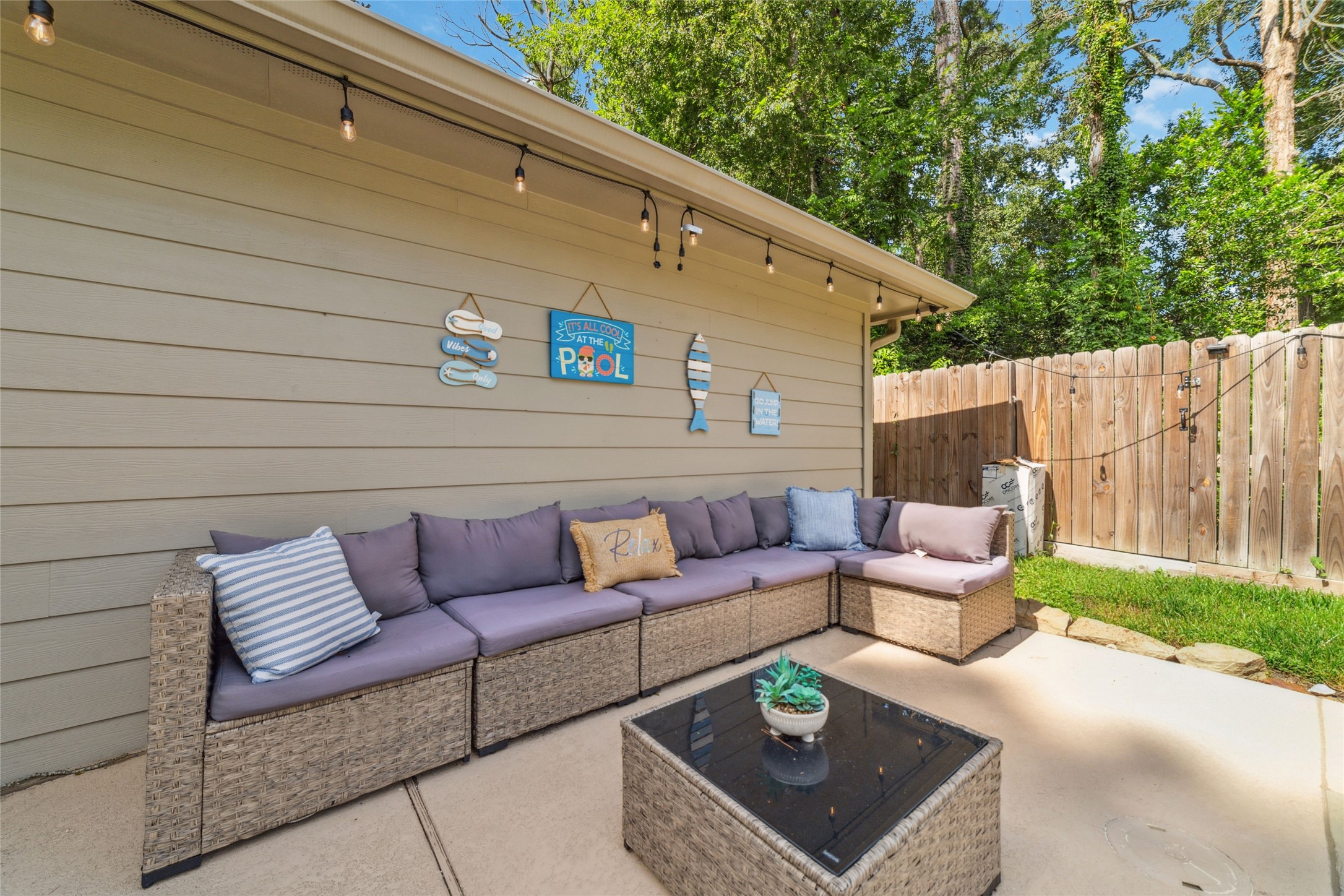 563 Landfall Lane Conroe, TX 77302 - Photo 4 of 25 a outdoor living space with a couch and a potted plant