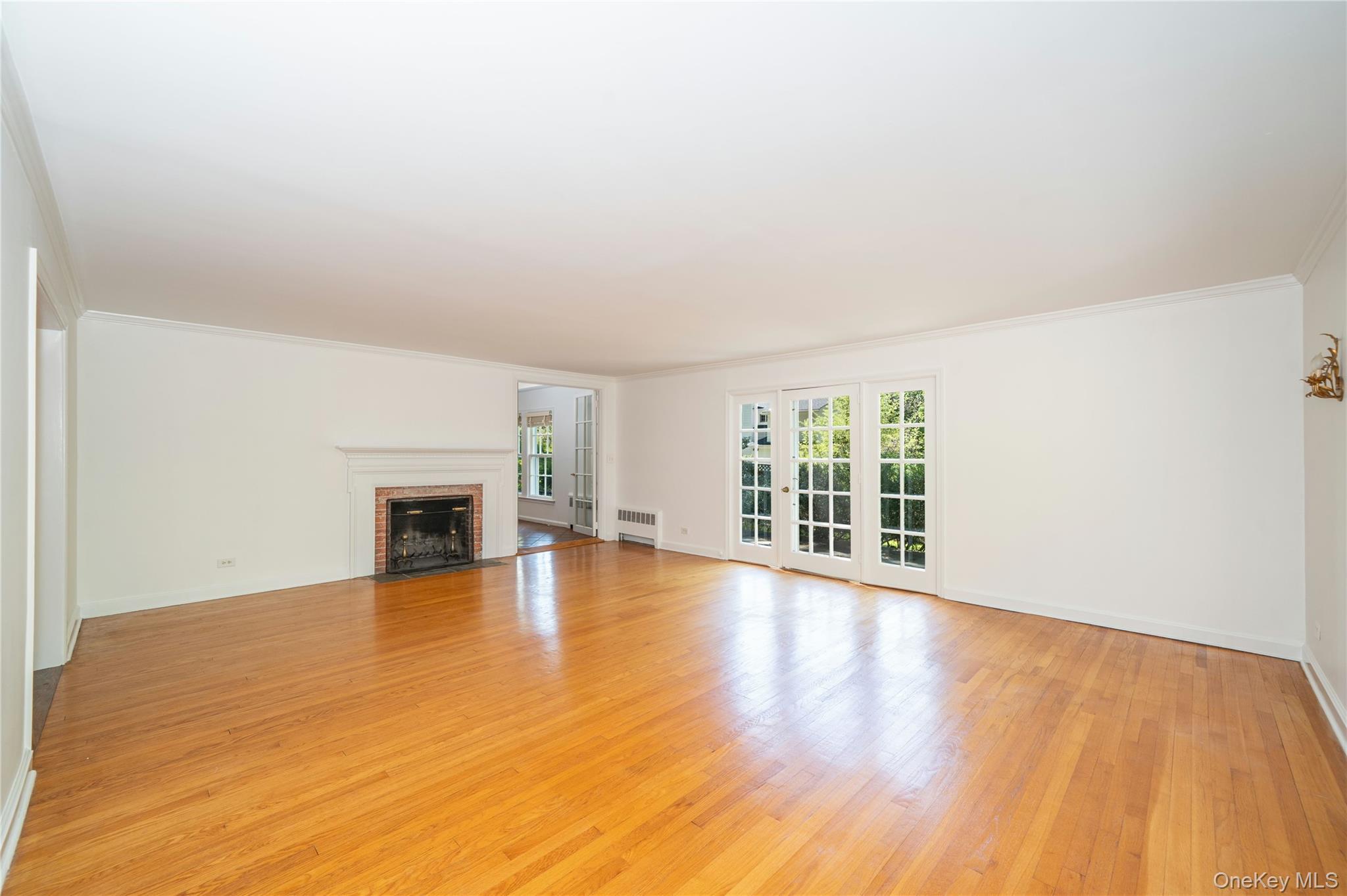 105 Douglas Road Chappaqua, NY 10514 - Photo 4 of 18 a view of an empty room with wooden floor and a window