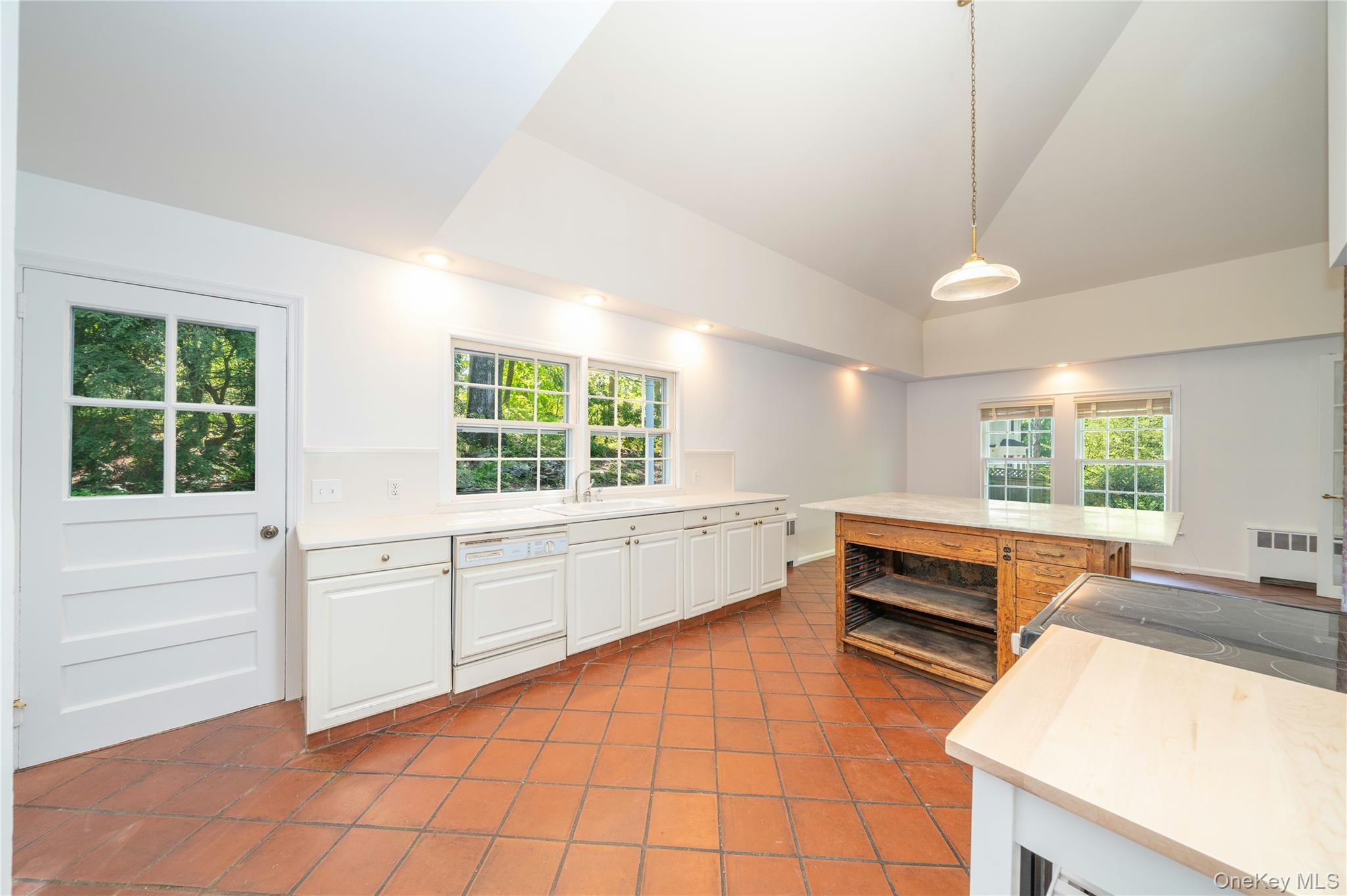105 Douglas Road Chappaqua, NY 10514 - Photo 6 of 18 a kitchen with stainless steel appliances a sink and a large window