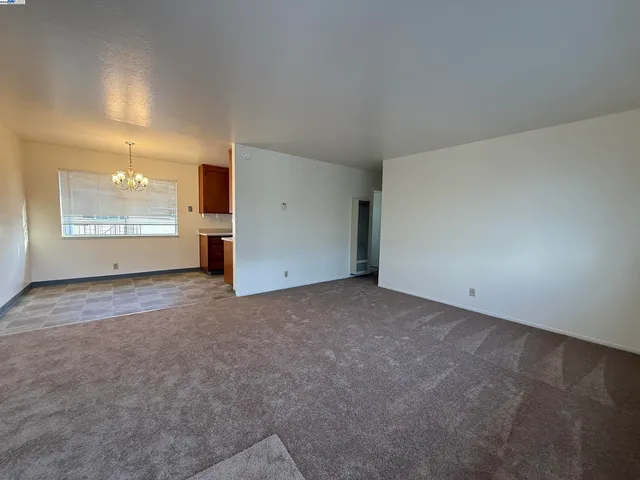 an empty room with a empty space and windows