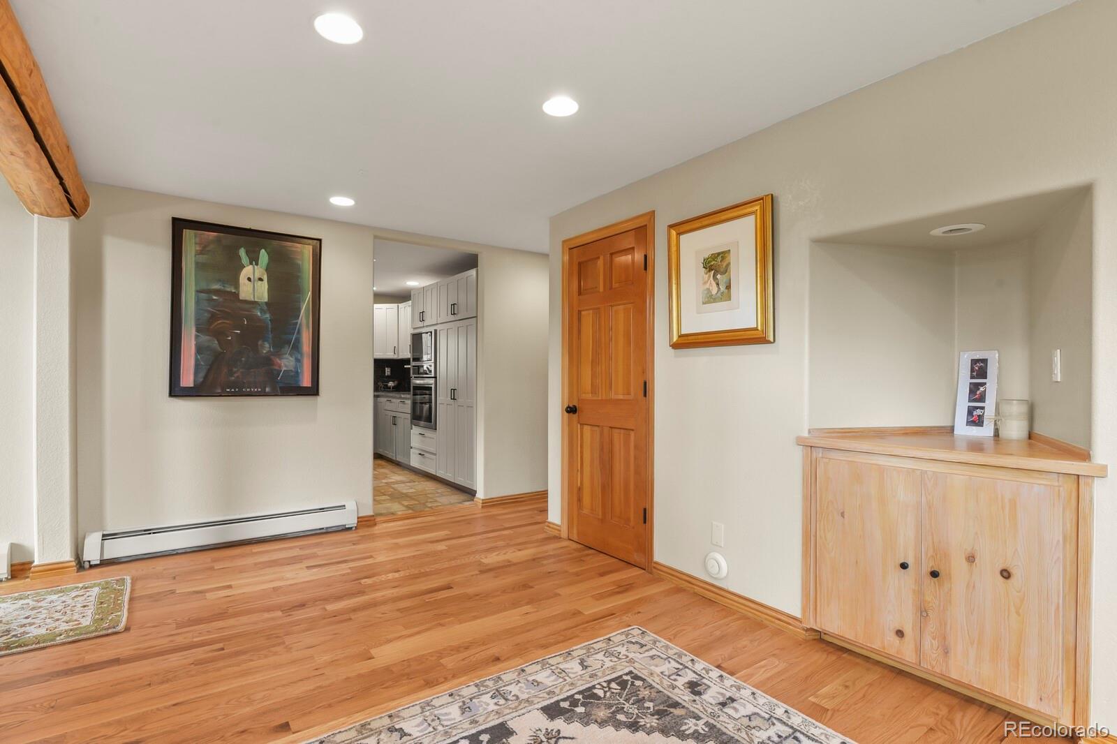 417 Witter Gulch Road Evergreen, CO 80439 - Photo 11 of 50 a view of a kitchen with wooden floor and a window