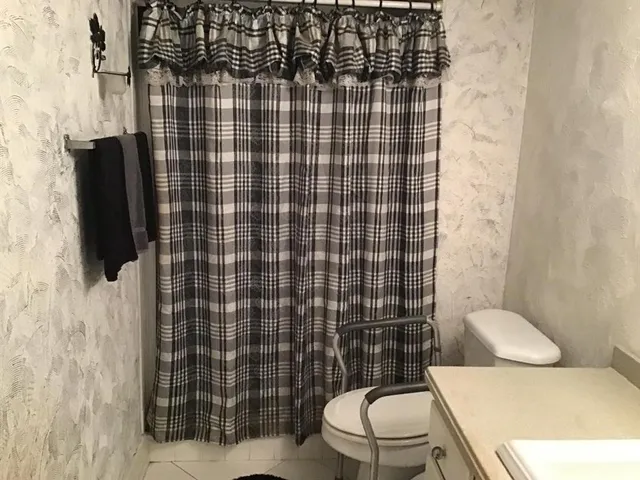 a bathroom with a toilet and a shower