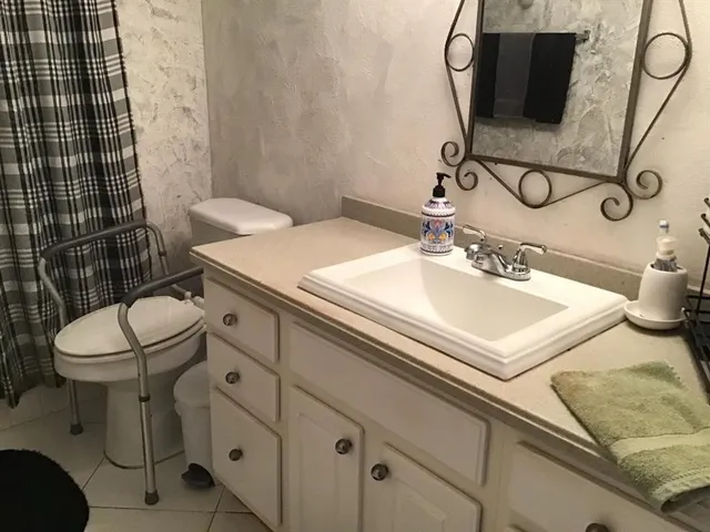 a bathroom with a sink toilet and mirror