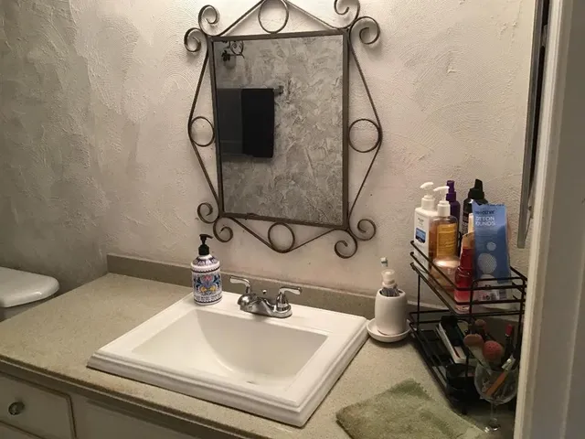 a bathroom with a sink and mirror
