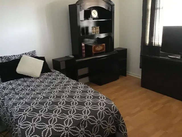 a bedroom with a bed and dresser