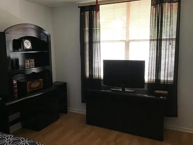 a living room with a flat tv screen and a bookshelf