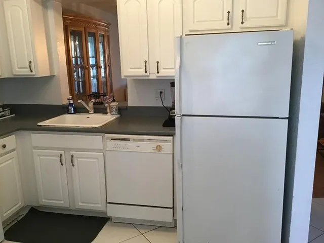 a white refrigerator freezer sitting inside of a kitchen